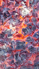 Vertical background from a fire, conflagrant firewoods and coals