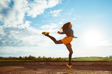girl in skirt jumps high