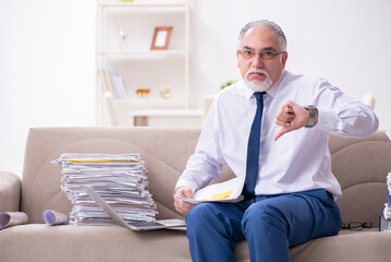 Aged businessman employee working from house