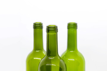 Three green empty wine bottles on a white background