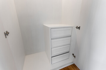 Close-up of the room's white wood cabinets