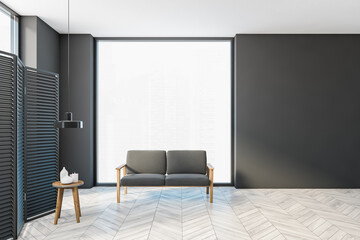 Grey large hall with sofa and small table, wooden screen near window