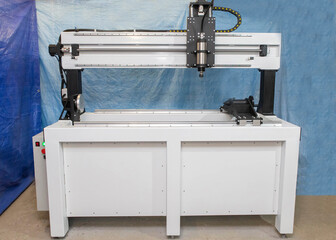 white milling machine with Computer numerical control standing in the workshop