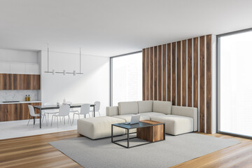 White living room with sofa near window and dining table with chairs