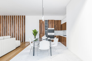 White room with kitchen and dining table with white chairs on white floor