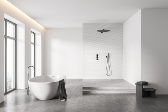 White bathroom interior with tub and shower stall