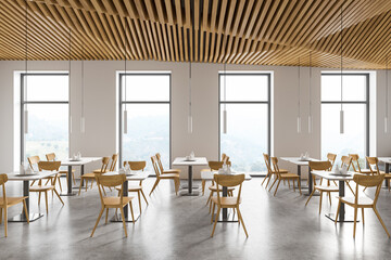 Modern white restaurant interior with square tables