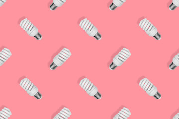 Light bulb seamless pattern. Lighting bulbs on a red background.