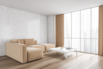 Beige sofa and big coffee table in living room with wooden floor and window