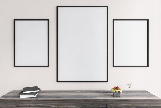 Mockup frames in living room on white wall above wooden desk with books