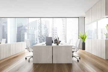 Wooden office with chairs and wooden tables, windows with city view