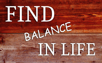 Inspirational motivational quote Find balance în life, on wooden background.