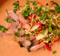 Macro photo of vegetable cream soup with shrimps
