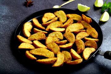 Healthy eating concepts- fresh baked potato wedges with spices.