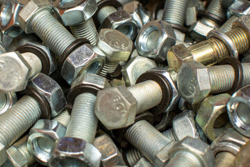 Сlose up of bright and shiny nuts, bolts and washers. Industrial background.	