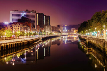 Naklejka na ściany i meble Night cityscape of Bilbao Basque Country Spain with its river, bridges and buildings. 