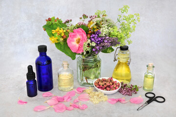 Obraz na płótnie Canvas Naturopathic herbal medicine with summer flowers and herbs with oils to make aromatherapy essential oil. Still life for natural health care concept. 