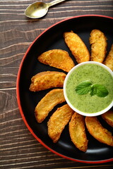 Fresh made potato wedges served with sauce. 