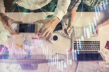 Double exposure of man and woman working together and financial chart hologram drawing. market...