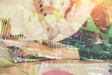 Multi exposure of woman hands typing on computer and financial graph hologram drawing. Stock market...