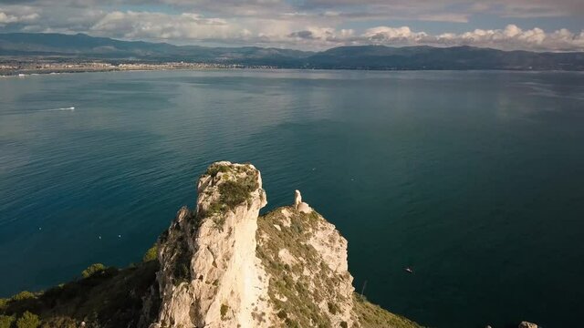Seascape Aerial Shot saddle of the devil (sella del diavolo) with calm sea in Caglairi - Sardinia.