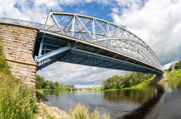 Fototapeta na wymiar Fisheye view on the first in Russia steel arch bridge across the Msta river