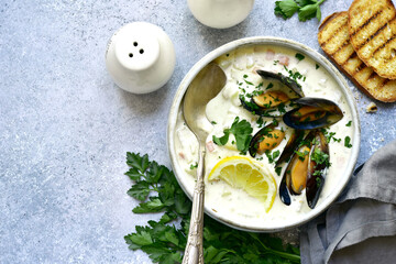 Chowder - delicious fish soup with mussels. Top view with copy space.