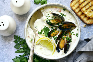 Chowder - delicious fish soup with mussels. Top view with copy space.
