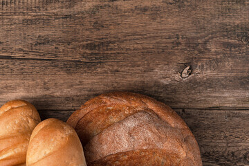 Cooking background with bread on wooden background. Top view with space to copy. Concept of culinary backgrounds.