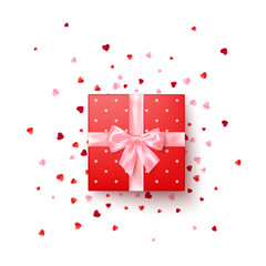 Fototapeta premium Realistic red gift box with pink silk bow decorated confetti top view. Vector illustration