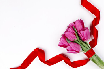 Tulip flowers and ribbon on white