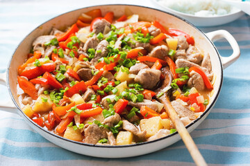 Sweet and sour Chinese chicken with pineapple, red pepper, chives