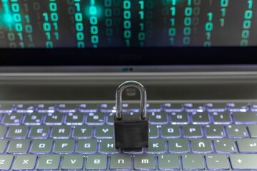 Lock on laptop as computer protection and cyber safety concept. Private data protection from hacker...