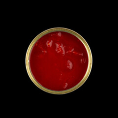 open can of tomatoes in tomato sauce isolated on a black background close-up, top view