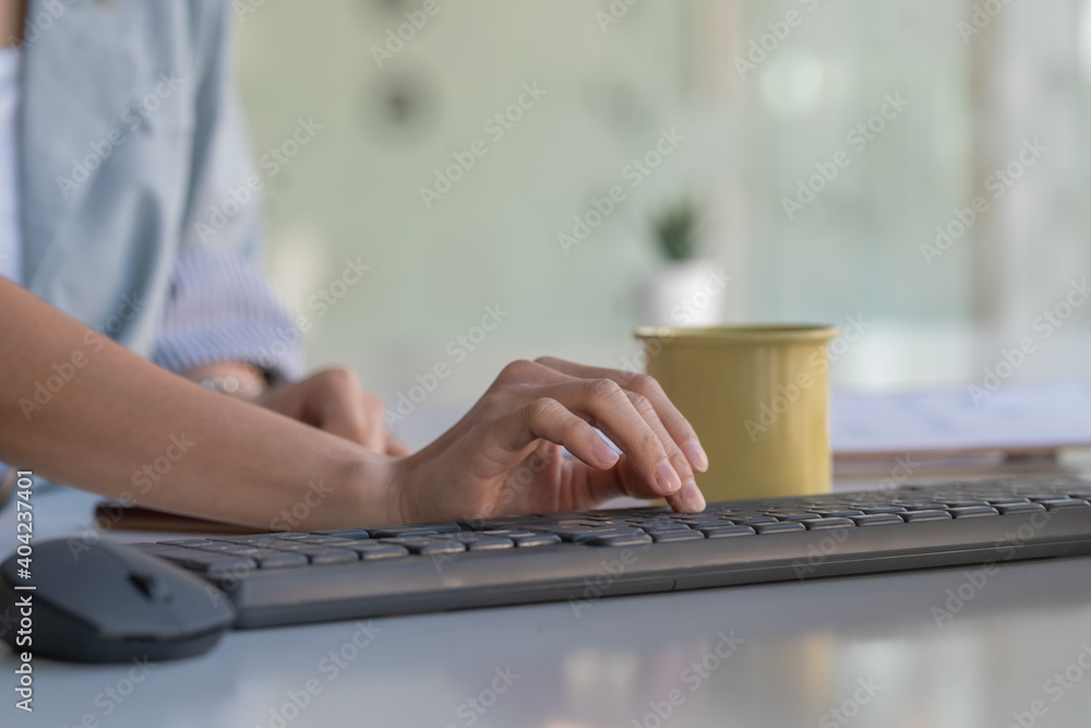 Poster close-up of person's hand typing on computer keyboard.