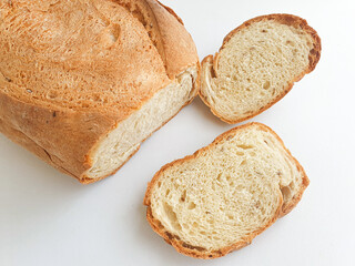 loaf of bread. Sliced fresh bread. Closeup freshly baked homemade traditional bread on white background. Concept - Cooking at Home