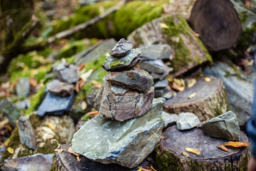 Fototapeta na wymiar stone stack, tower or pyramid of stones in the forest, balance