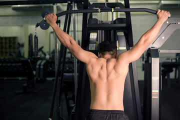 Fototapeta na wymiar Bodybuilder man with big muscular back in the gym