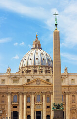 Fototapeta na wymiar Tall Egyptian obelisk, made of red granite with bronze lions and Chigi arms on the top, in the center of St. Peter's Square, Vatican City. Famous Italian landmark