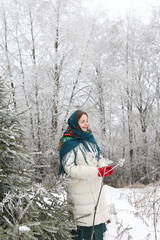 Russian tourist girl in Pavlovo Posad shawl, scarf. Snow. Forest, winter landscape. Winter nature....