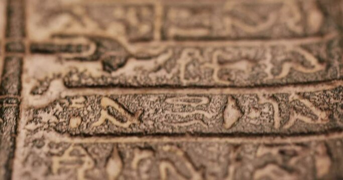Shallow depth of field (selective focus) and close up footage with Egyptian hieroglyphs on a historic replica.
