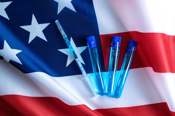 Vaccine usa isolated. Medical syringe with needle for protection flu virus and coronavirus. Covid immunization on american flag background. Concept fight against virus covid-19.