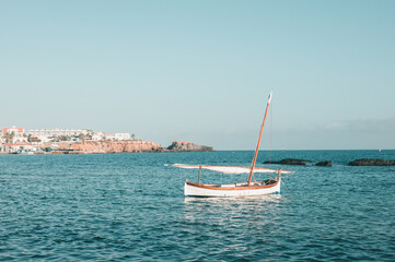 One small white boat in the mediterranean sea