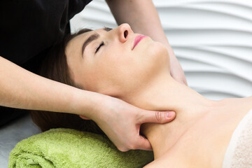 Neck and throat massage. Strong finger pressure on the skin.