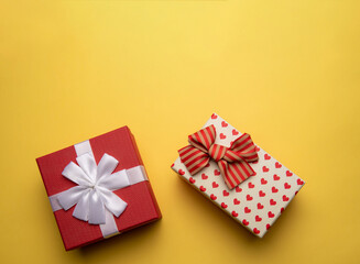 Red and white gift box with on yellow background,flat lay