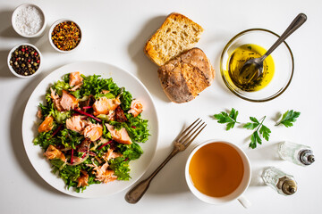 Salmon salad - roasted salmon with mix of vegetables on white background

