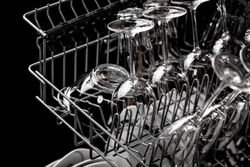 Clean dishes in the dishwasher. Wine glasses, sparkling wine glasses. Close-up. Washing-up and...