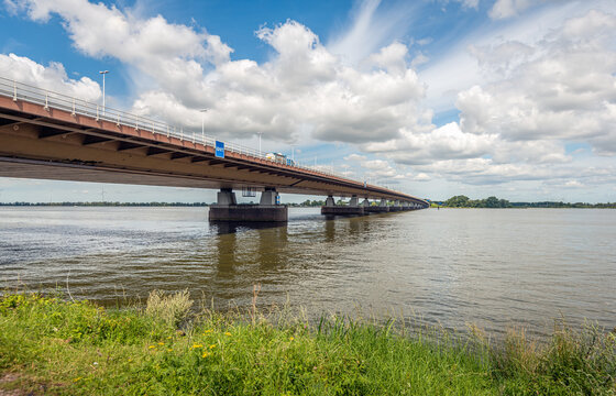 Moerdijk road bridge over the Hollandsch Diep river seen from the southern bank in the province of Noord-Brabant. The photo was taken on a sunny day in the summer season.