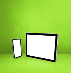 Mobile phone and digital tablet pc on green office desk