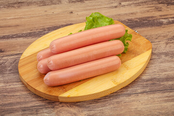 Tasty meat sausages over board